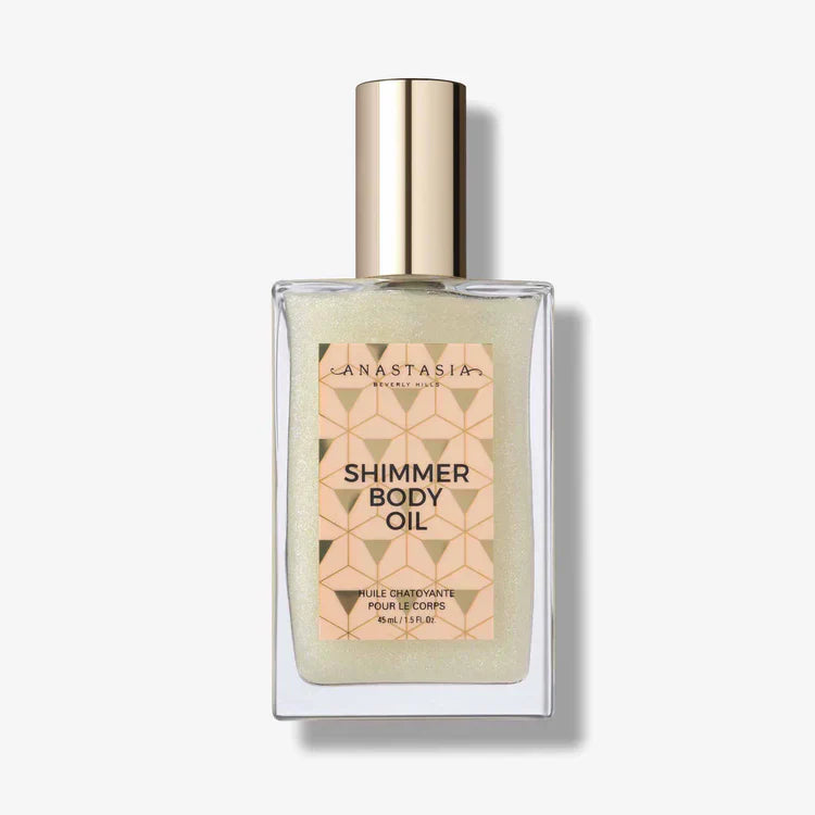 Shimmer body oil in a clear glass bottle with gold cap for radiant skin glow