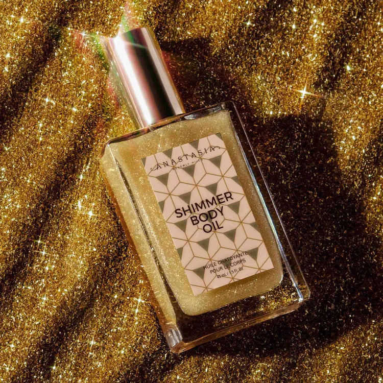 Anastasia shimmer body oil bottle on sparkling gold glitter background, luxury skincare