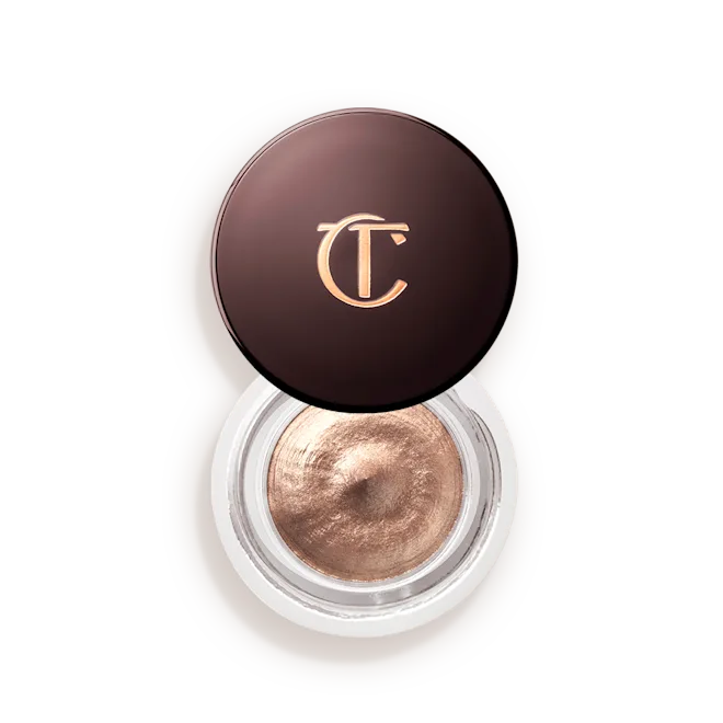 Champagne cream eyeshadow in open round jar with metallic brown lid, luxury makeup