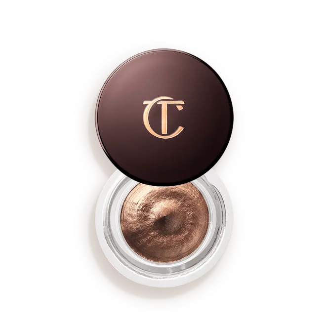Creamy chocolate bronze eyeshadow in a round clear jar with dark brown lid and gold logo