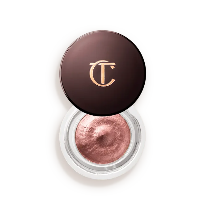 Shimmery rose gold cream eyeshadow in a round jar with a dark lid and gold logo
