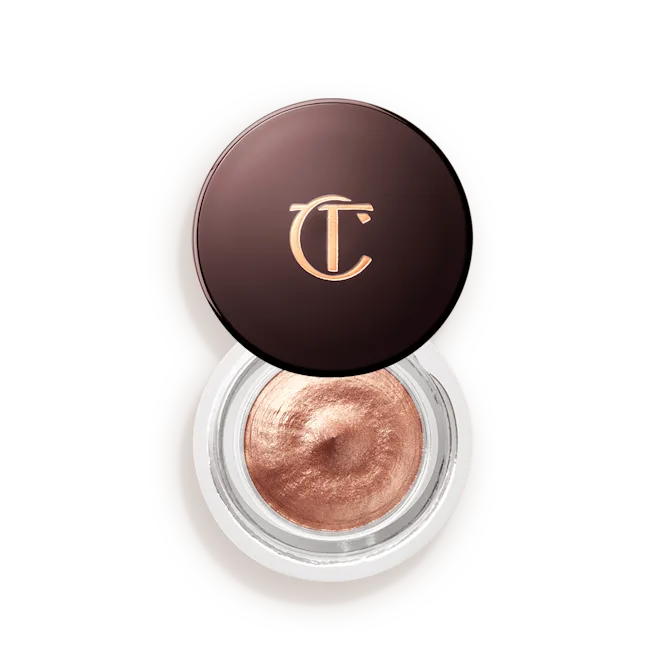 Rose gold cream eyeshadow in a round jar with a dark lid featuring gold initials