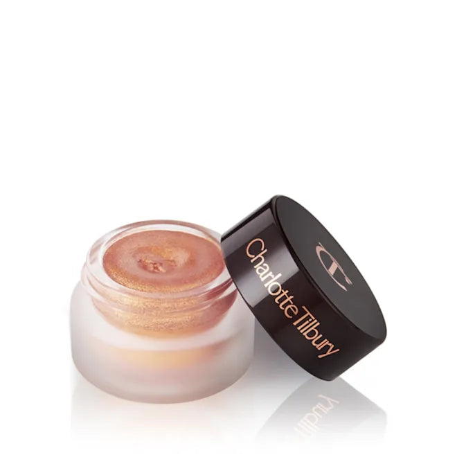 Charlotte Tilbury cream eyeshadow in a glass pot with shimmery bronze shade and open lid