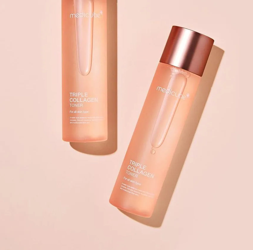 Two MediCube Triple Collagen Toner bottles for all skin types on a light peach background.