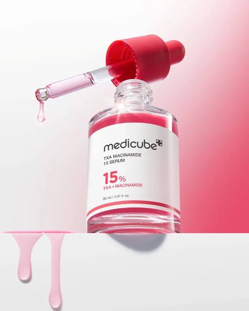 Medicube TXA Niacinamide 15 serum bottle with dropper, skincare product on pink gradient background