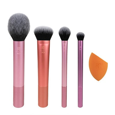 Set of four makeup brushes and an orange blending sponge on a white background.